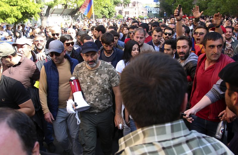 Armenian protest leader Nikol Pashinian, center, marches with other demonstrators celebrating Armenian Prime Minister’s Serzh Sargsyan’s resignation in Republic Square in Yerevan, Armenia, Monday, April 23, 2018.