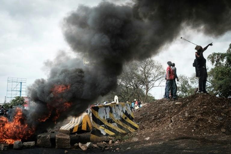 Opposition supporters block streets and burn tires during a protest in Kisumu, Kenya