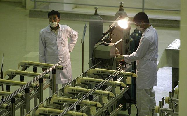 Iranian technicians working at a facility producing uranium fuel for a planned heavy water nuclear reactor, outside Isfahan, in 2009