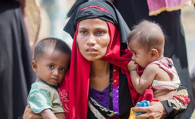 Rohingya Muslim woman, Rukaya Begum, who crossed over from Myanmar into Bangladesh, holds her son Mahbubur Rehman, left and her daughter Rehana Bibi