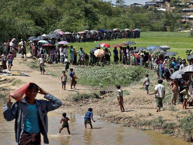 Rohingya refugees queue for aid in Cox's Bazar, Bangladesh, October 1, 2017.