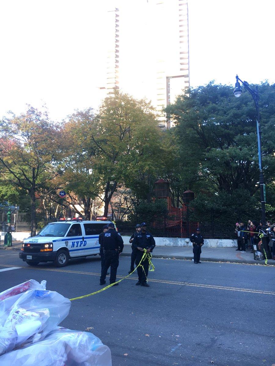 NYPD officers clear streets as several emergency vehicles come in towards Stuyvesant high school 