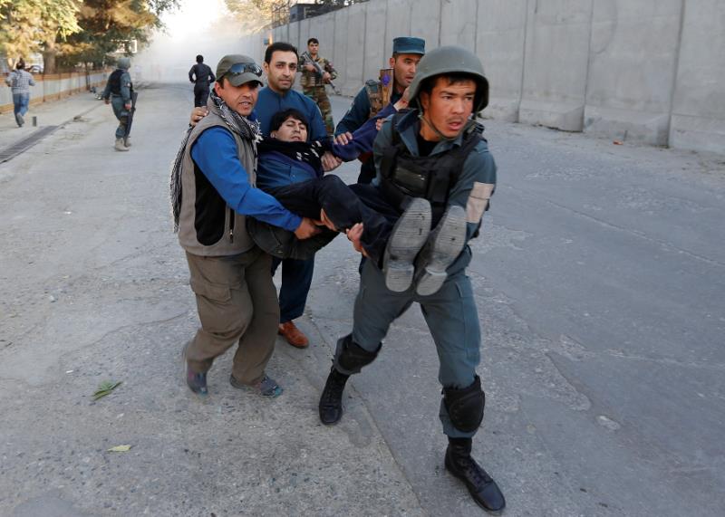  Afghan policemen carry an injuried after a blast in Kabul October 31, 2017.
