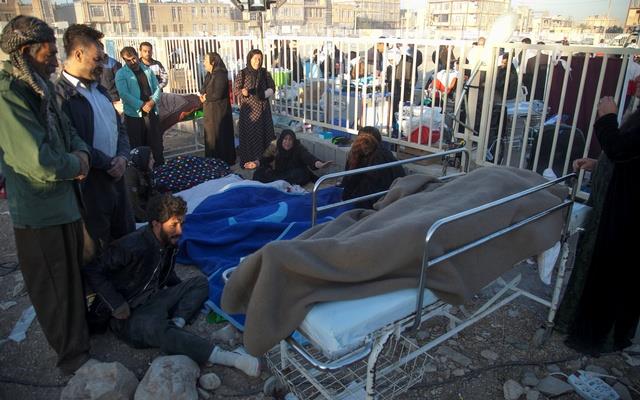 People react next to dead bodies following an earthquake in Sarpol-e Zahab county in Kermanshah, Iran Nov 13, 2017.