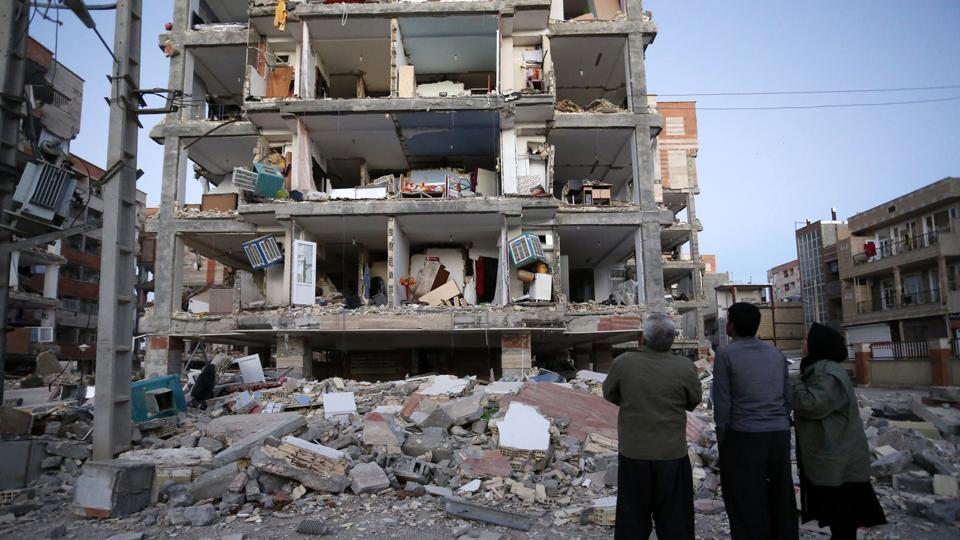  In this photo, people look at destroyed buildings after an earthquake at the city of Sarpol-e-Zahab in western Iran