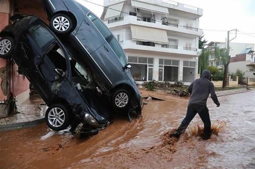 A man walks through a waterlogged area in Mandra, west of Athens, Greece, on Nov. 15, 2017