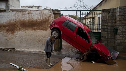 A woman inspects the damage in the municipality of Mandra in western Athens
