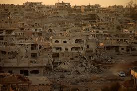 A truck drives through a damaged street in a rebel-held area of the southern city of Daraa on Nov.16