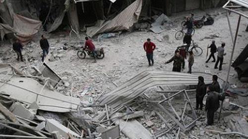 People inspect the debris of a building after airstrikes in Damascus on Nov. 20
