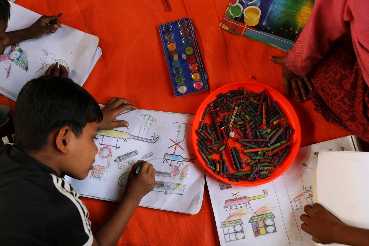 Rohingya refugee children spend time drawing at a UNICEF centre in Balukhali refugee camp near Cox's Bazar, Bangladesh, November 22, 2017