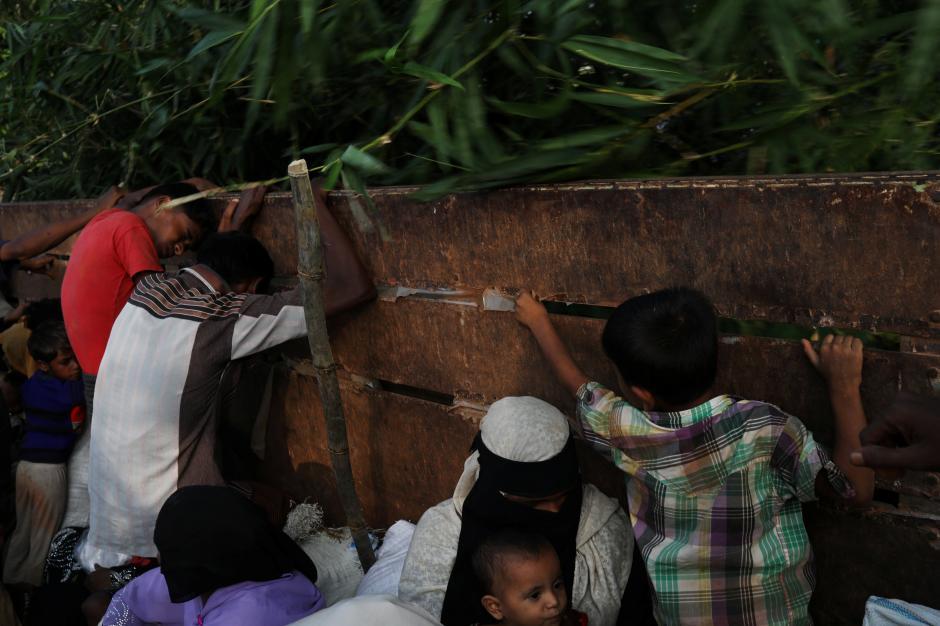 Newly arrived Rohingya refugees try to avoid branches as they ride a truck to a registration point after crossing the Bangladesh-Myanmar border at a relief centre in the Teknaf area, Bangladesh, November 23, 2017