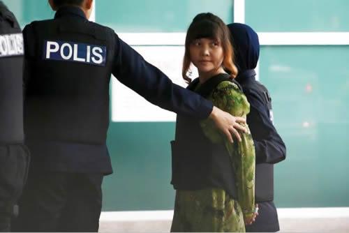 FILE PHOTO: Vietnamese Doan Thi Huong who is on trial for the killing of Kim Jong Nam, the estranged half-brother of North Korea's leader, is escorted as she arrives at the Department of Chemistry in Petaling Jaya, near Kuala Lumpur, Malaysia October 9, 2017.