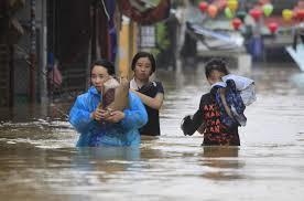 People wade through flooded street of Hoi An ancient town, Vietnam, Monday, Nov. 6, 2017.