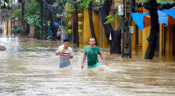 Residents wading through floodwaters in Hoi An.