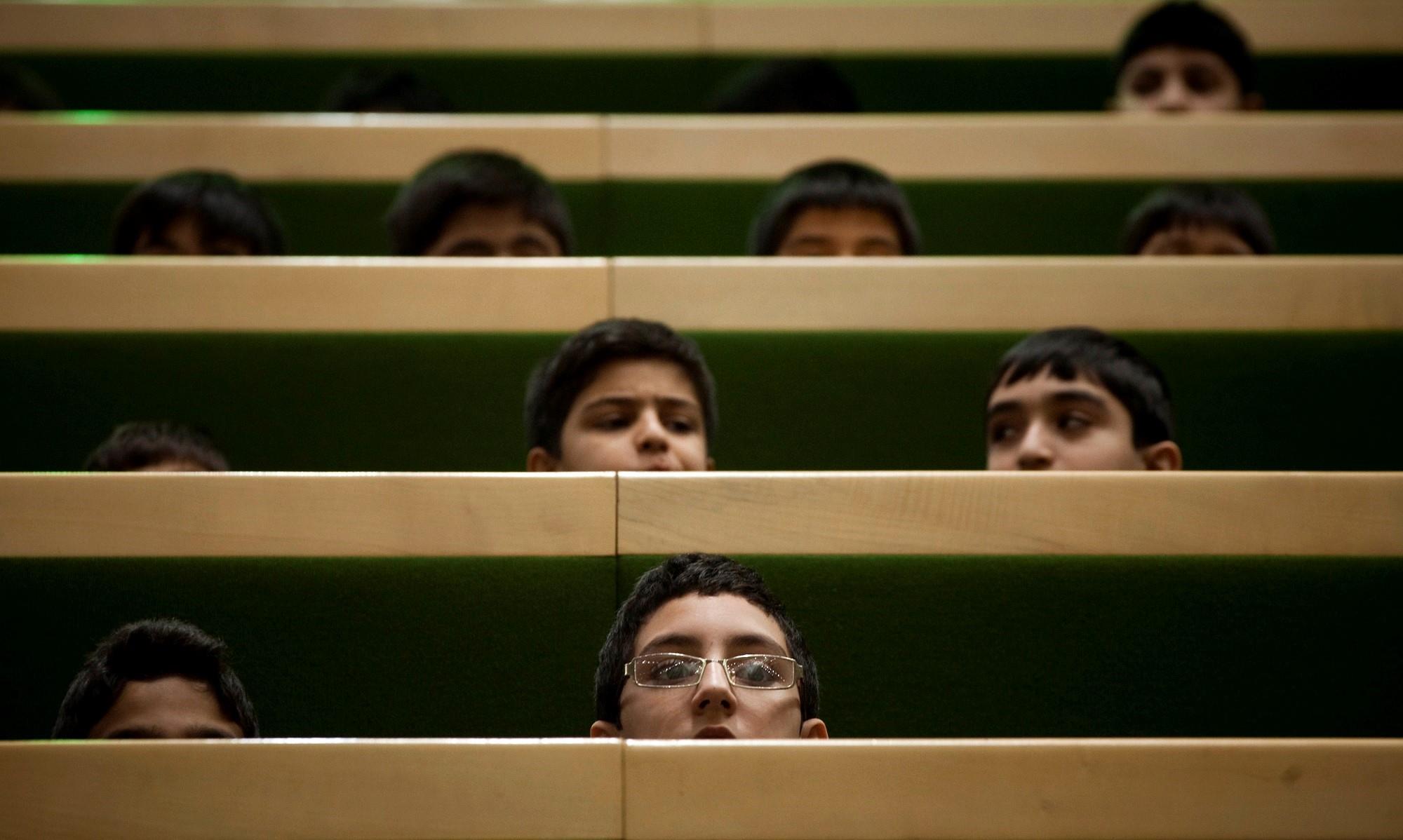 Schoolboys attend a session of the Iranian parliament in Tehran on December 11, 2011. 