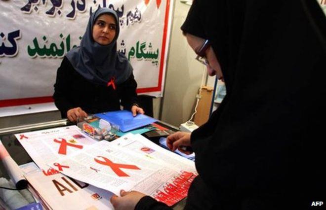 An Iranian woman reads a leaflet at an exhibition marking World Aids Day in Tehran