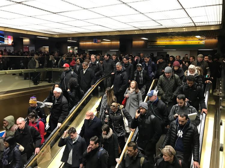 Commuters exit the New York Port Authority in New York City, December 11, 2017 after reports of an explosion.