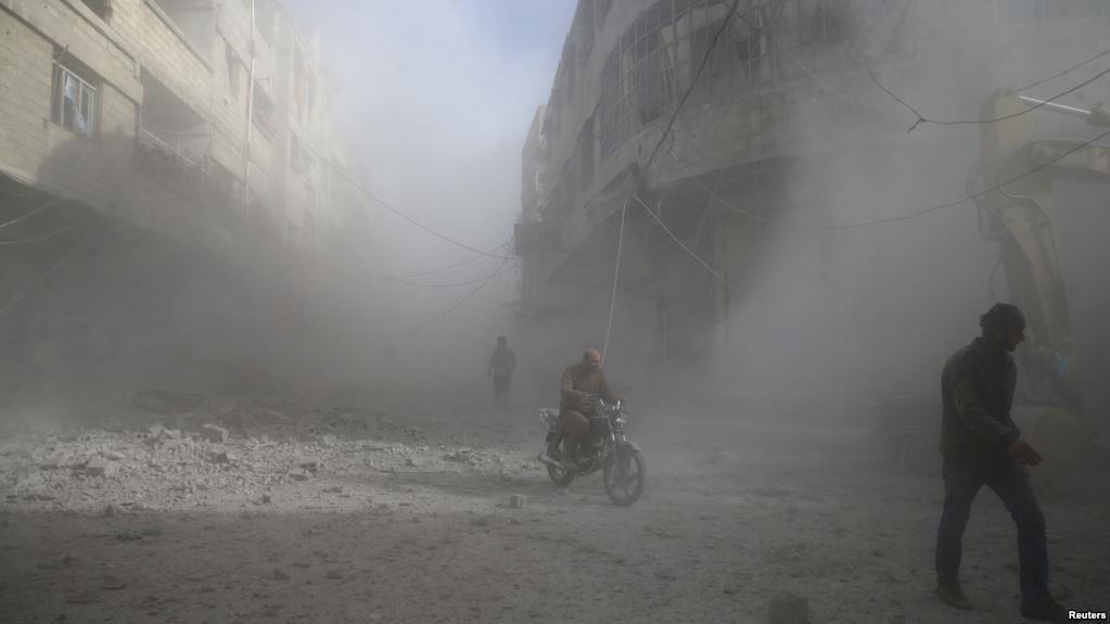 People are seen during shelling in the town of Hamoria, eastern Ghouta in Damascus, Syria, Dec. 3, 2017.