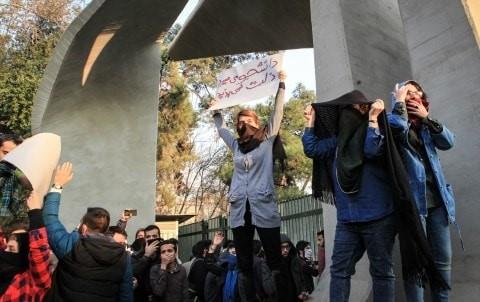 Students clash with police during an anti-government protest around the University of Tehran on Dec. 30
