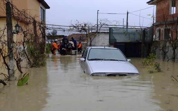  Albania flooding Dec 1. Authorities help a family evacuate from their home after heavy rainfall