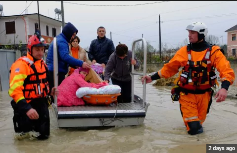Authorities help a family evacuate from their home after heavy rainfall in the village of Hasan, about 25 kilometers (15 miles) north of Tirana, Friday 
