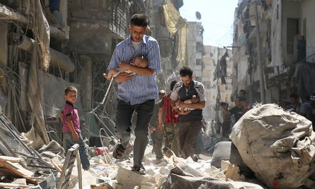  Syrian men cradle babies as they navigate the rubble of destroyed buildings after an air strike on Aleppo’s Salihin district in September 2016