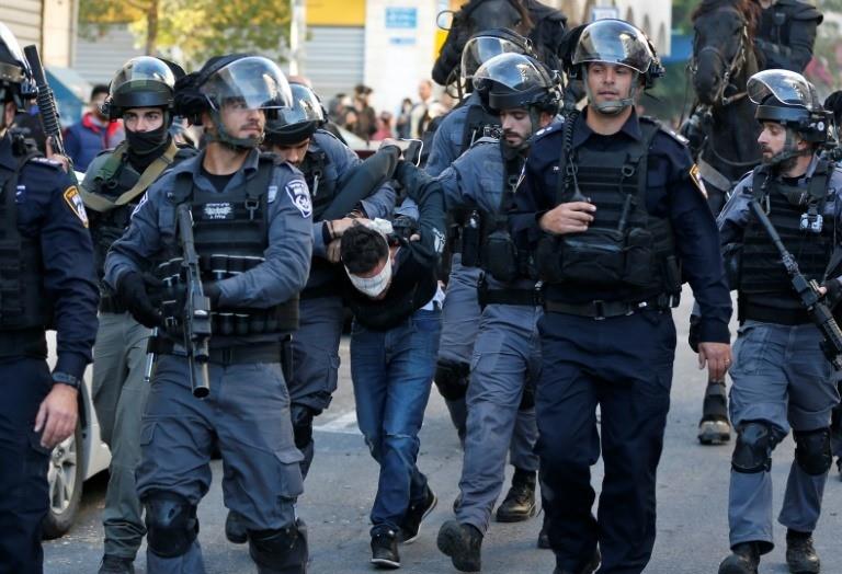 Israeli security forces detain a Palestinian protester on December 9, 2017, in annexed east Jerusalem where police dispersed a protest