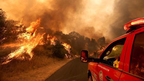 A firefighters maneuvers his vehicle as the Alamo fire burns near Santa Maria