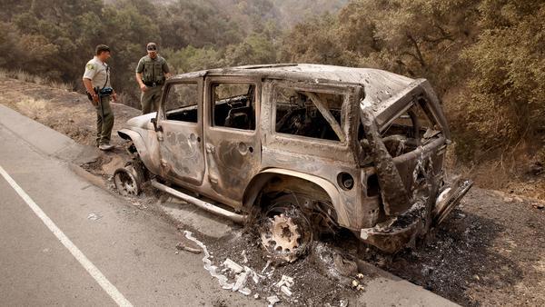 Santa Barbara County Sheriff's Deputy B. Bruening, left, and U.S. Fish and Wildlife warden Max Magleby inspect a Jeep that was abandoned