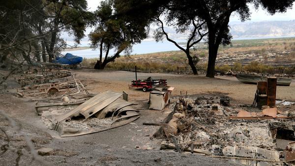 The remains of a structure and boats scorched by the Whittier fire in Los Padres National Forest near Lake Cachuma