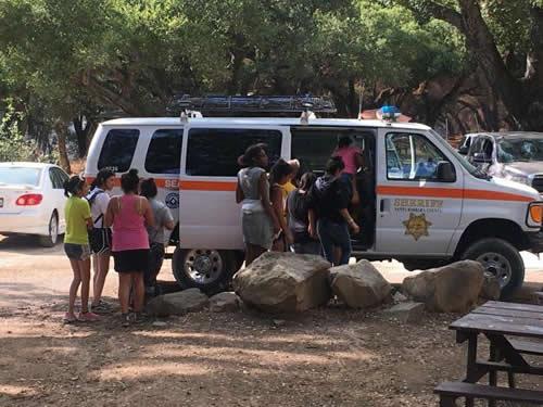 Youths are evacuated by sheriff's deputies from a campground near the Whittier wildfire near Santa Ynez, California, U.S. July 9, 2017
