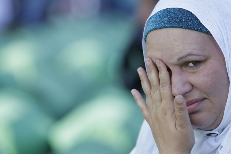 Bosnian Muslim woman cries near the coffin of her relative during a funeral ceremony for dozens of newly identified victims of the 1995 massacre, at the memorial centre of Potocari near Srebrenica, 150 kms north east of Sarajevo, Bosnia, Tuesday, July 11, 2017.