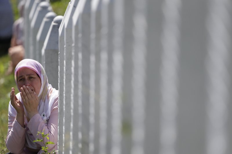 A Bosnian Muslim woman prays among gravestones during a funeral ceremony for dozens of newly identified victims of the 1995 massacre, at the memorial centre of Potocari near Srebrenica, 150 kms north east of Sarajevo, Bosnia, Tuesday, July 11, 2017