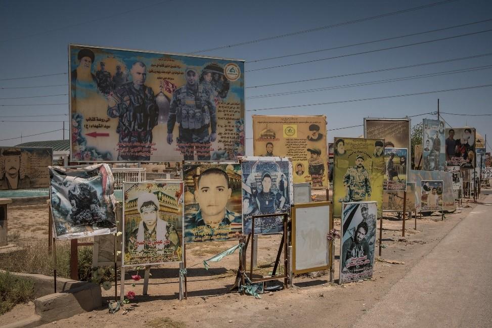 Portraits of members of Iraqi forces and Shiite militia groups at a cemetery in Najaf. 
