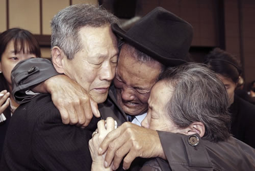 FILE - In this Oct. 22, 2015, file photo, North Korean Son Kwon Geun, center, weeps with his South Korean relatives as he bids farewell after the Separated Family Reunion Meeting at Diamond Mountain resort in North Korea. South Korea’s Red Cross said on Monday, July 17, 2017