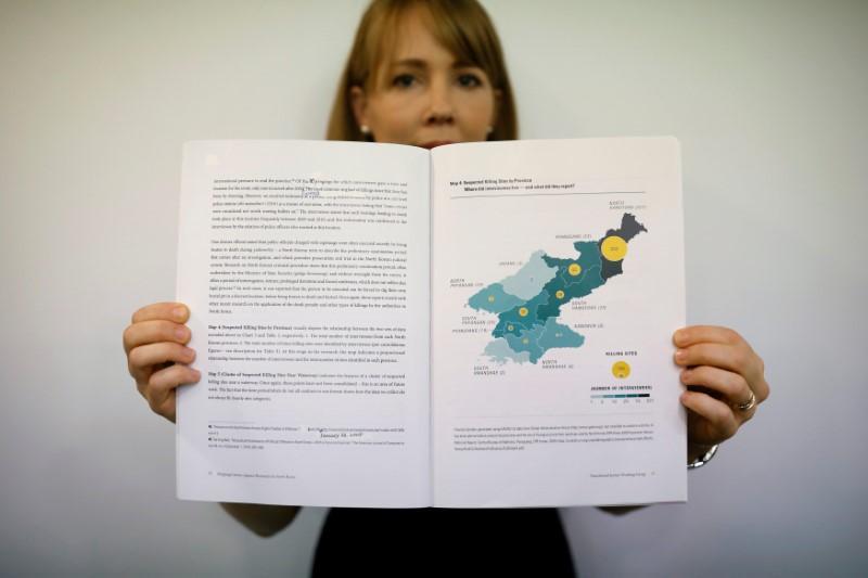  Sarah Son, research director of Transitional Justice Working Group, poses for photographs with a graphic showing suspected killing sites in North Korea in a report compiled by the group during an interview in Seoul, South Korea, July 19, 2017.
