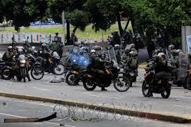Riot security forces take position while clashing with demonstrators rallying against Venezuela's President Nicolas Maduro's government in Caracas 