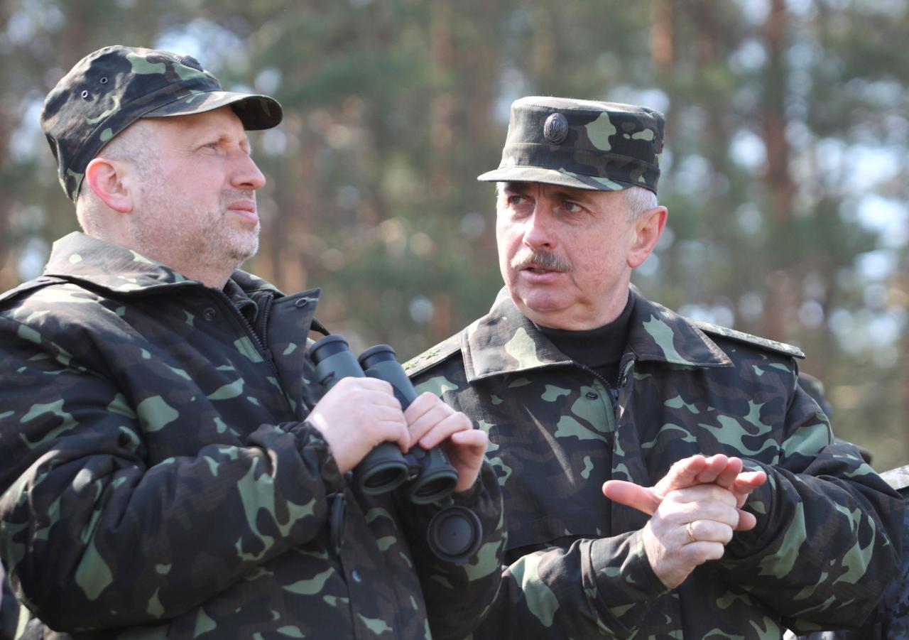 Ukrainian acting President Oleksander Turchinov (L) and acting Defence Minister Mykhailo Koval visit a military exhibition 