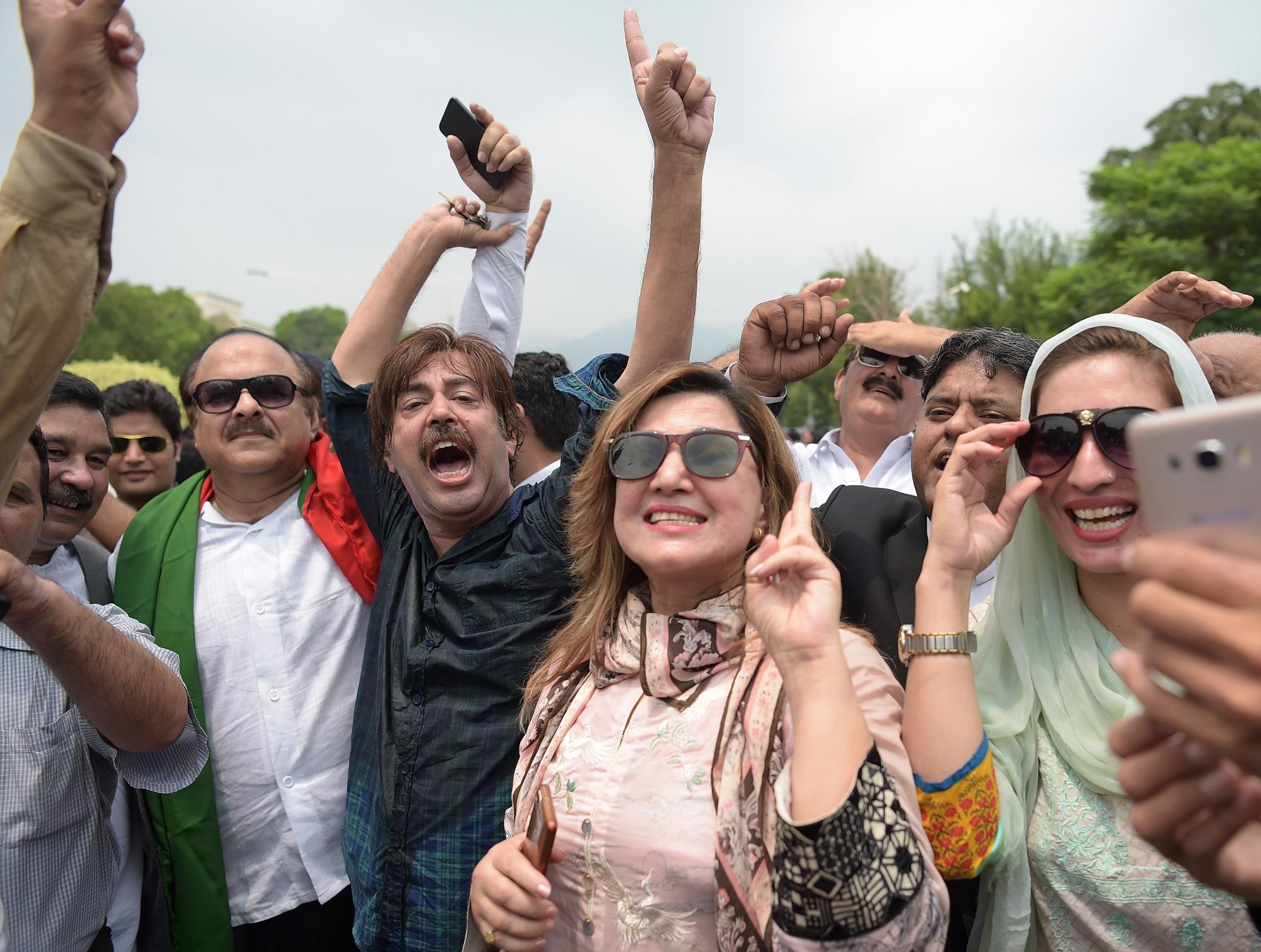 Opposition supporters of Imran Khan’s Pakistan Tehreek-i-Insaf (PTI) party celebrate after the verdict in Islamabad on July 28, 2017. (AFP)