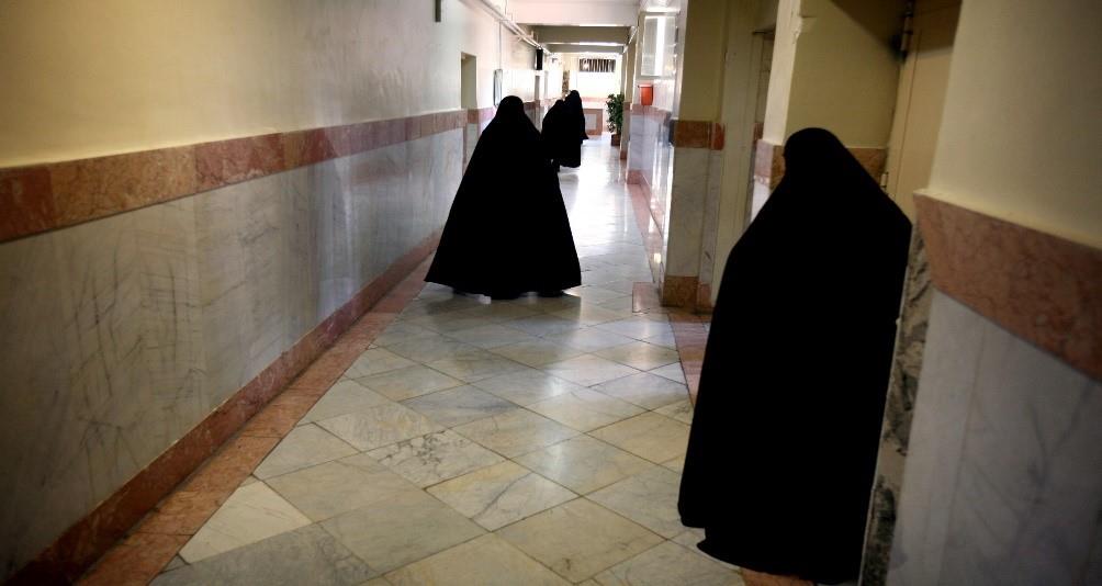 Female prison guards walk along a corridor in Tehran's Evin prison 