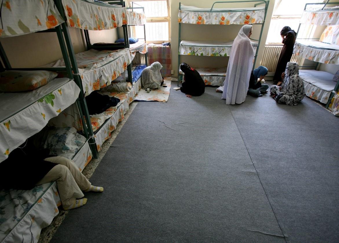 Iranian women prisoners sit inside their cell in Tehran's Evin prison June 13, 2006. 
