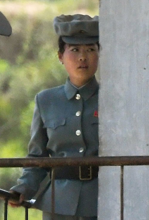 A North Korean female soldier guards the border near the Chinese border town of Dandong, northeastern Liaoning province of China