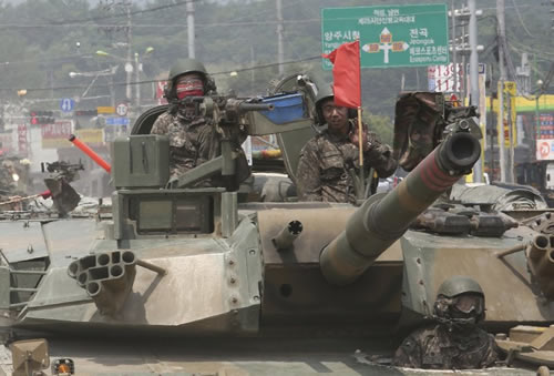  South Korean army soldiers ride a K-1 tank during the annual exercise in Paju, South Korea near the border with North Korea