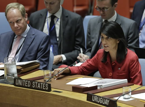 United Kingdom U.N. Ambassador Matthew Rycroft, left, listens as United States U.N. Ambassador Nikki Haley, right