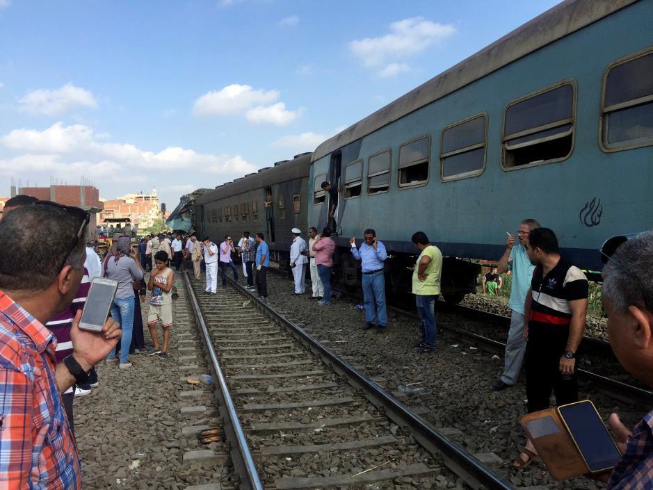 Egyptians look at the crash of two trains that collided near the Khorshid station in Egypt's coastal city of Alexandria, Egypt August 11, 2017.Osama Nageb