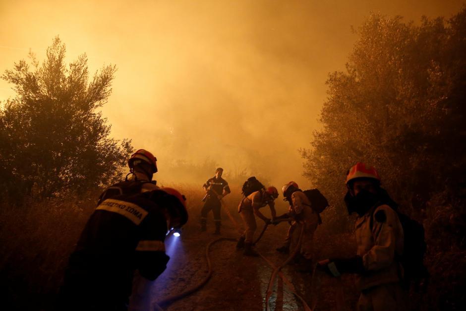  Firefighters try to extinguish a wildfire burning near the village of Kalamos, north of Athens, Greece, August 13, 2017.Costas Balta