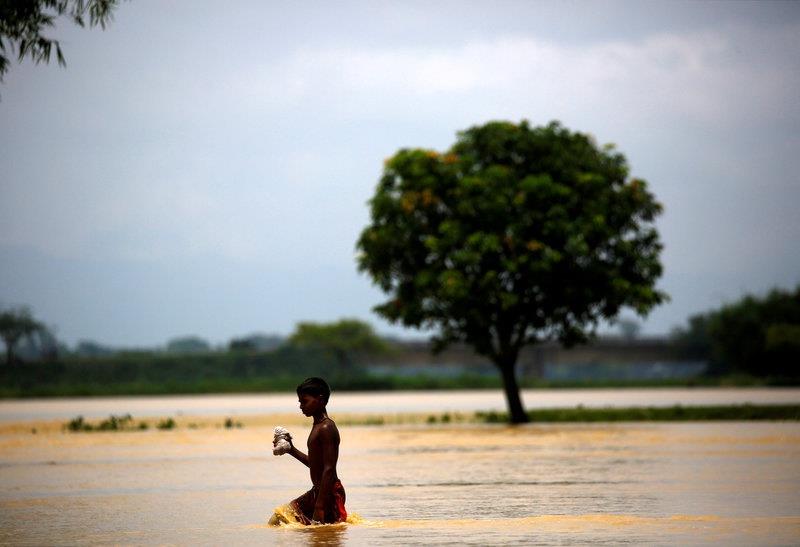  A boy walks along the flooded area in Saptari District, Nepal August 14, 2017.