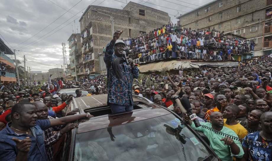 Kenyan opposition leader Raila Odinga gestures to thousands of supporters gathered in the Mathare area