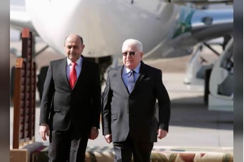 Iraq's President Fuad Masum (R) walks with Basra Governor Majid al-Nasrawi in Basra, southeast of Baghdad, Iraq February 23, 2015