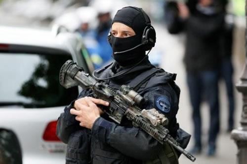 Police officers prepare to escort Salah Abdeslam outside police prefecture in Paris earlier today